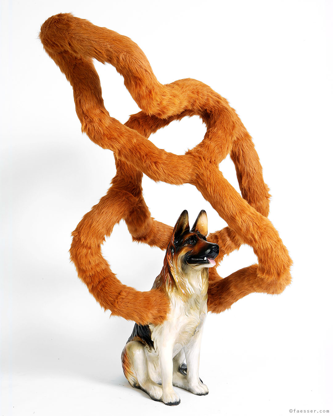 Fell ueber die Ohren gezogen: German shepherd with long wool tube over his body; work of art as figurative sculpture; artist Roland Faesser, sculptor and painter 2007