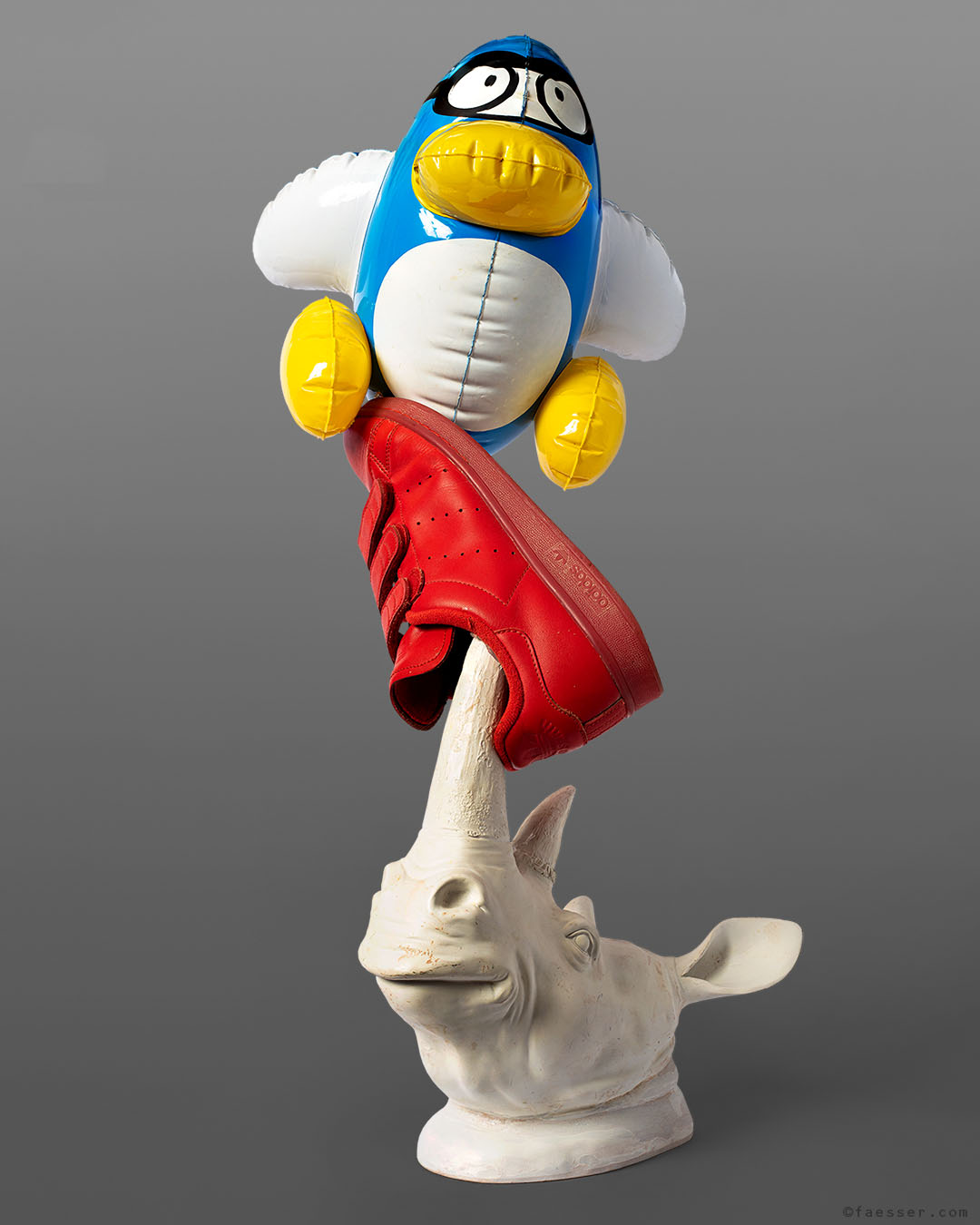 Rhinoceros head with Adidas Stan Smith sneaker and inflated comic figure; work of art as figurative sculpture; artist Roland Faesser, sculptor and painter 2019